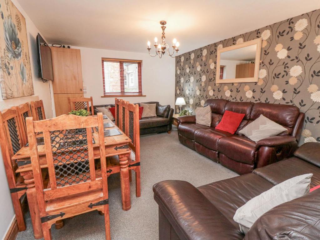 a living room with a couch and a table at Psalm Cottage in Scarborough