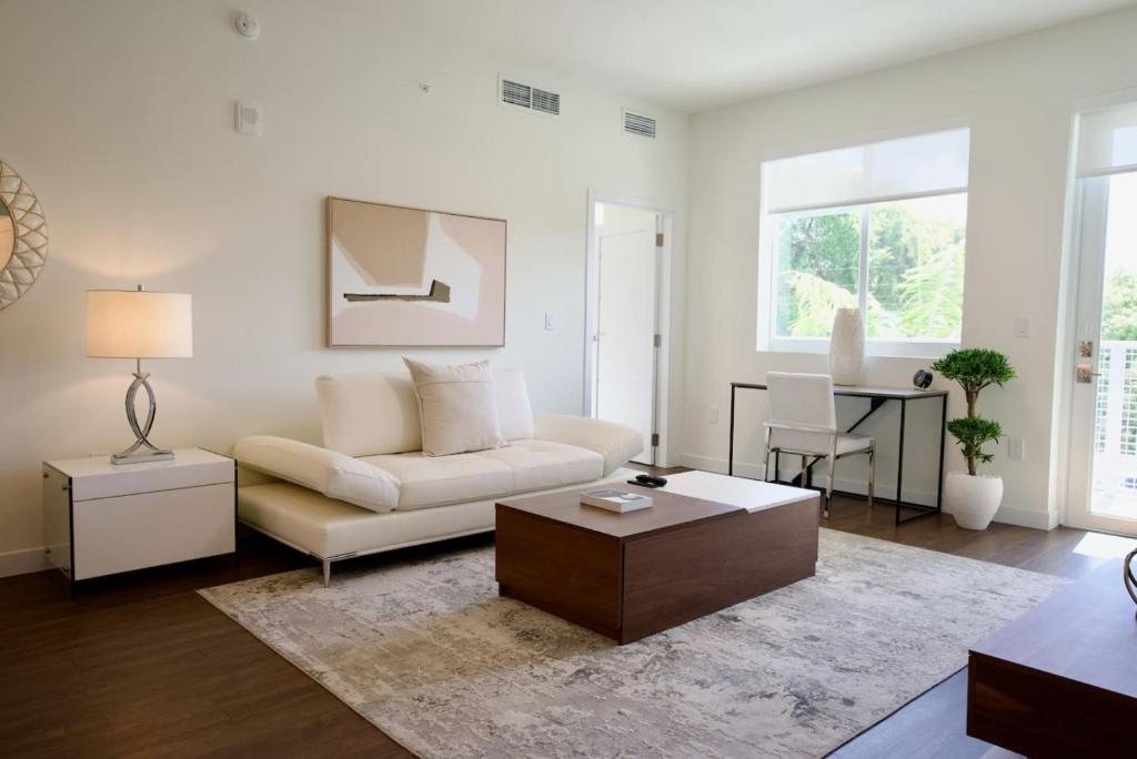 a living room with a couch and a table at Ivory at Aviara East Pompano in Pompano Beach