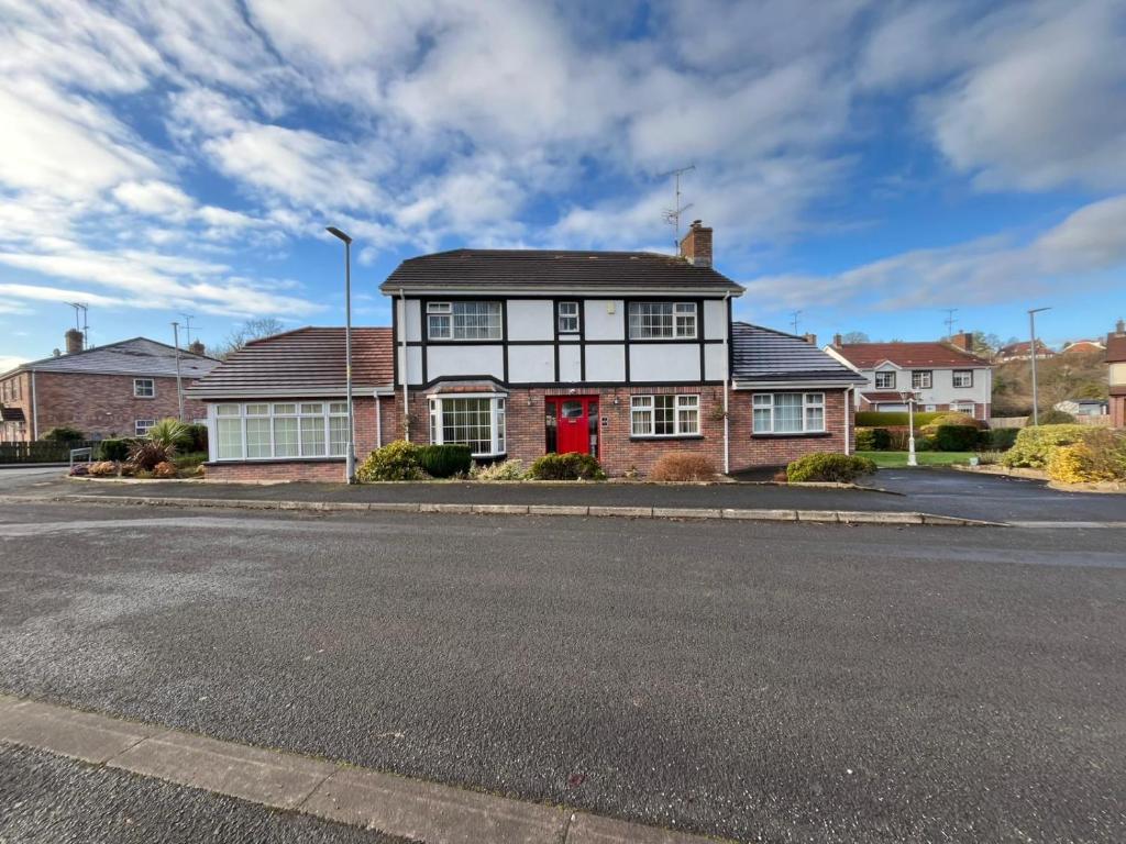 a house with a red door on a street at Portora House Accommodation ROOM ONLY-ALL ROOMS EN-SUITE in Enniskillen