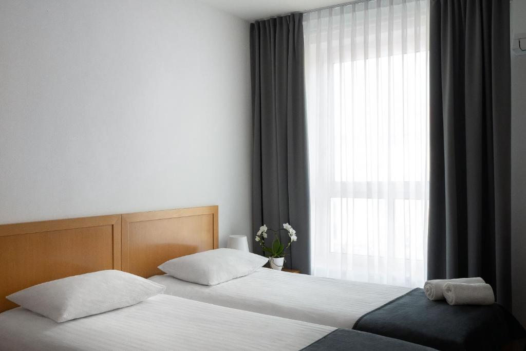Postel nebo postele na pokoji v ubytování Hotel Tabor