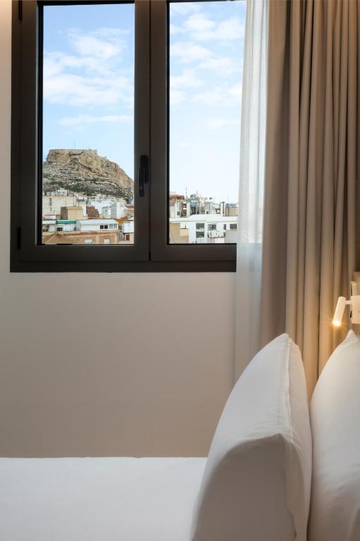 a room with a window with a view of a city at B&B HOTEL Alicante Centro in Alicante