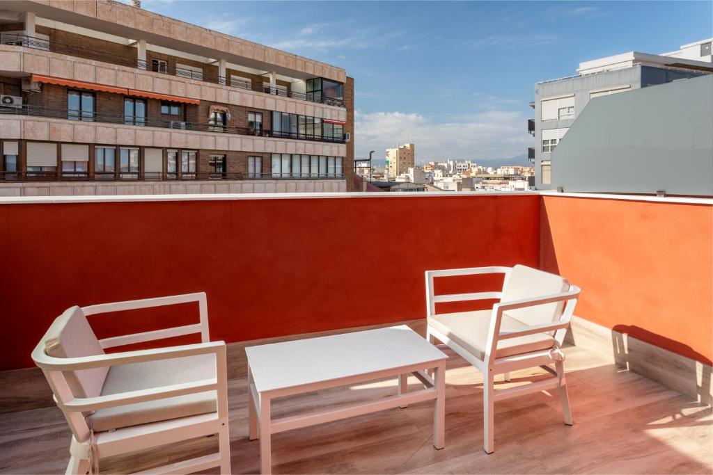 two chairs and a table and two chairs on a roof at B&B HOTEL Alicante Centro in Alicante