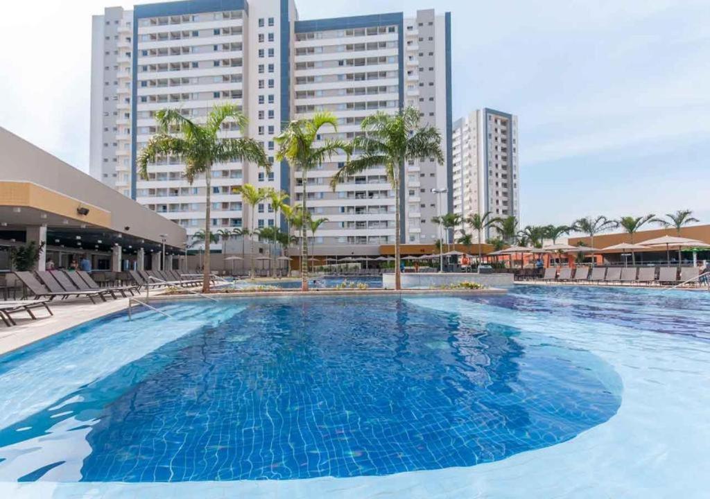 a large swimming pool in front of some buildings at SOLAR DAS AGUAS PARQUE RESORT in Olímpia