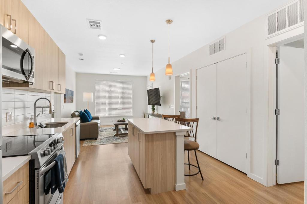 an open kitchen and living room with a kitchen island at My Sweet Rentals- 30 night min in Aurora