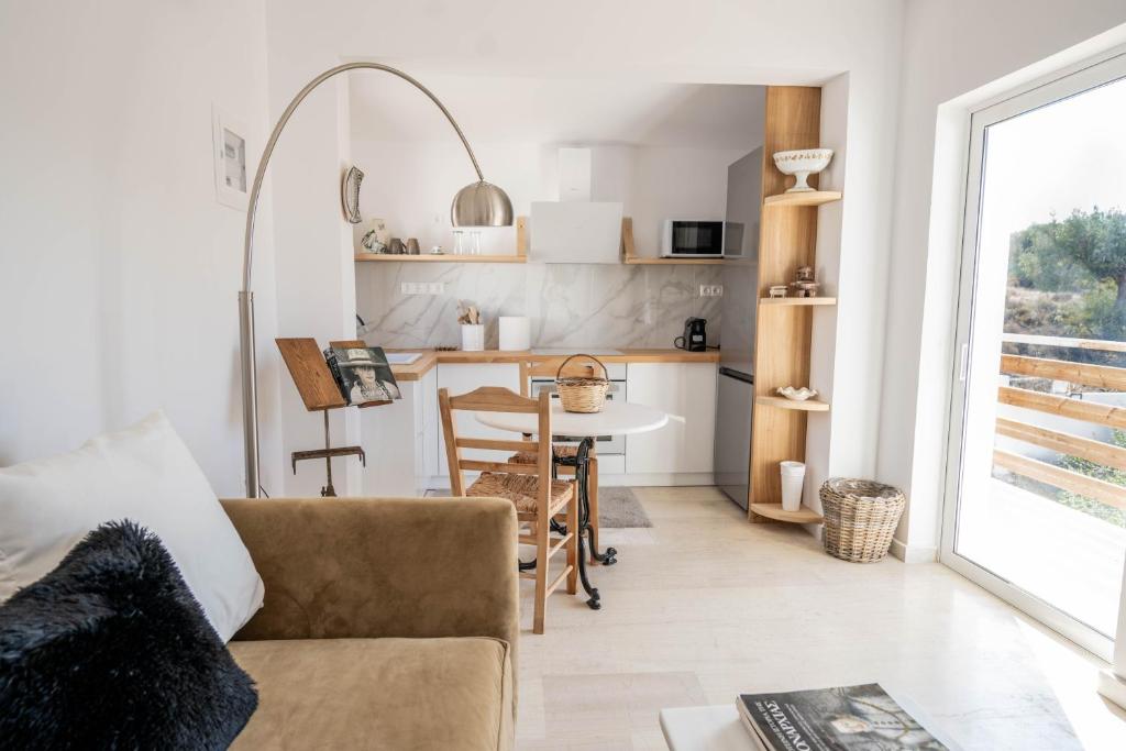 a living room with a couch and a table at Agrambeli Apartments at Heraion Lagoon -By Bellavista Greece- in Loutraki