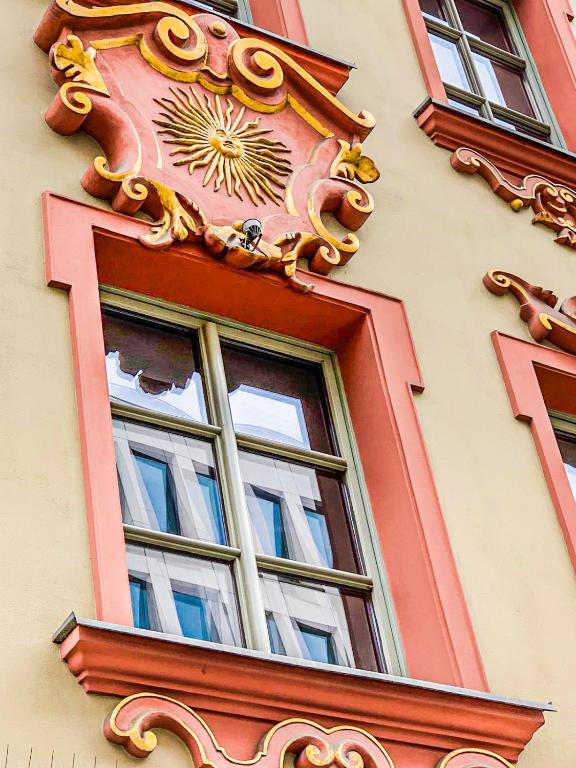 a window with a clock on the side of a building at Sunny Hostel 49 in Wrocław