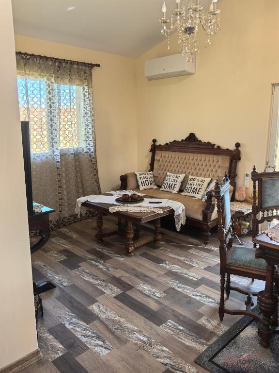 a living room with a couch and a table at Вила Езерото in Lipnik