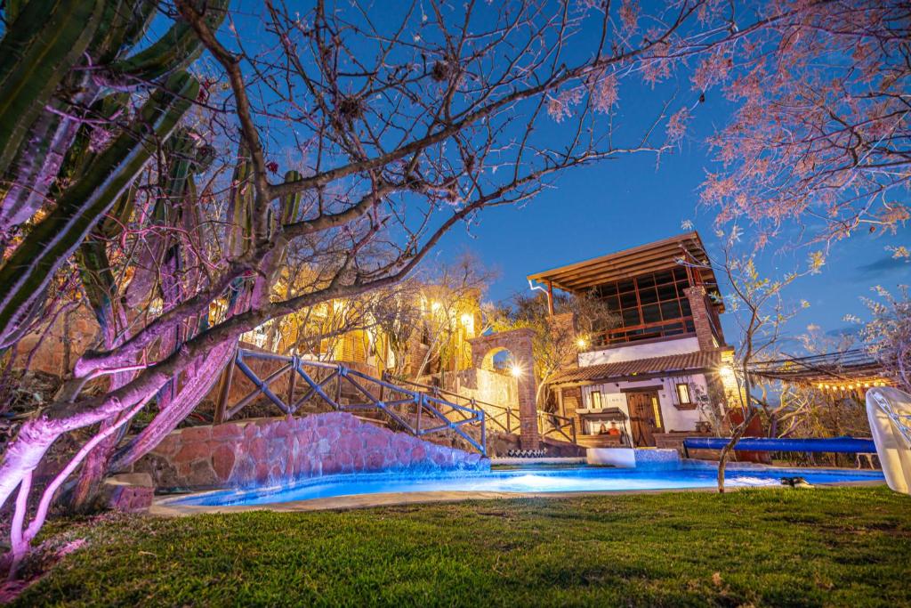 a house with a staircase leading up to it at night at Hotel Casa Cantera in El Carmen