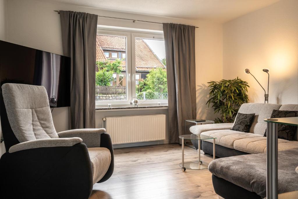 a living room with two chairs and a window at Ferienhaus Nia in Altenau