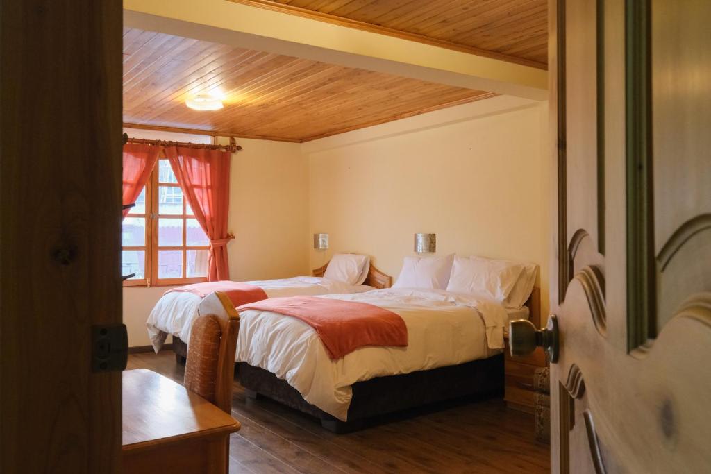 Postel nebo postele na pokoji v ubytování Maimara Hotel