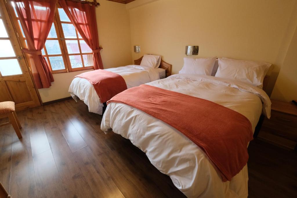 Postel nebo postele na pokoji v ubytování Maimara Hotel
