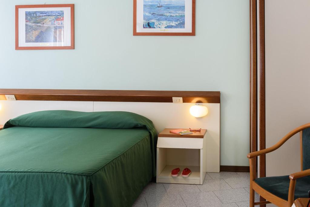 Postel nebo postele na pokoji v ubytování Hotel Italie et Suisse