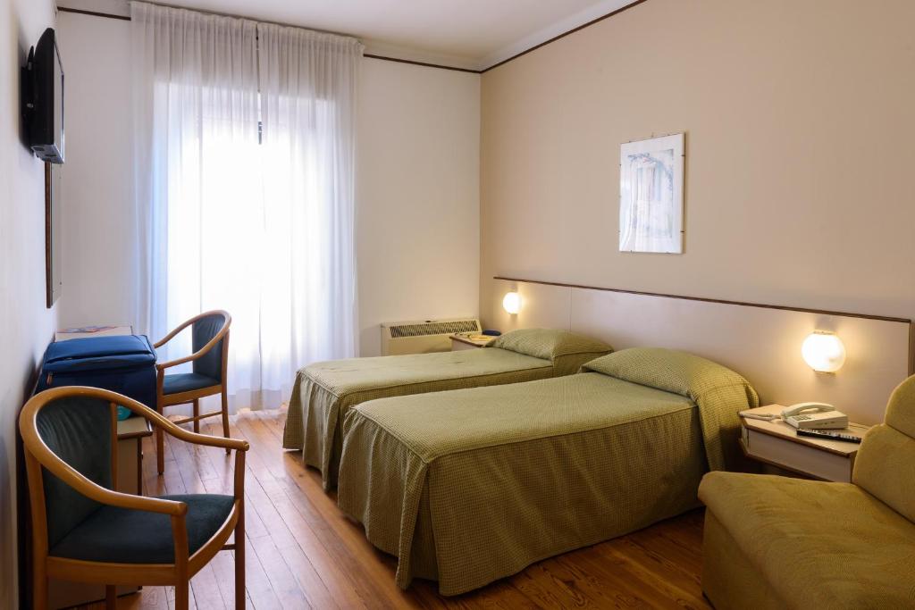 Postel nebo postele na pokoji v ubytování Hotel Italie et Suisse