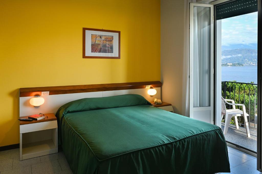 Postel nebo postele na pokoji v ubytování Hotel Italie et Suisse
