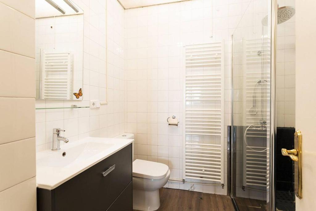 a bathroom with a toilet and a sink and a shower at S&C Apartments in Ilha da Madeira