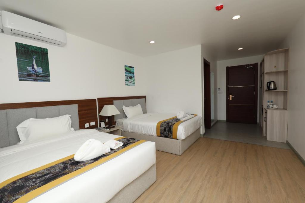 Postel nebo postele na pokoji v ubytování Yue Lai Hotel