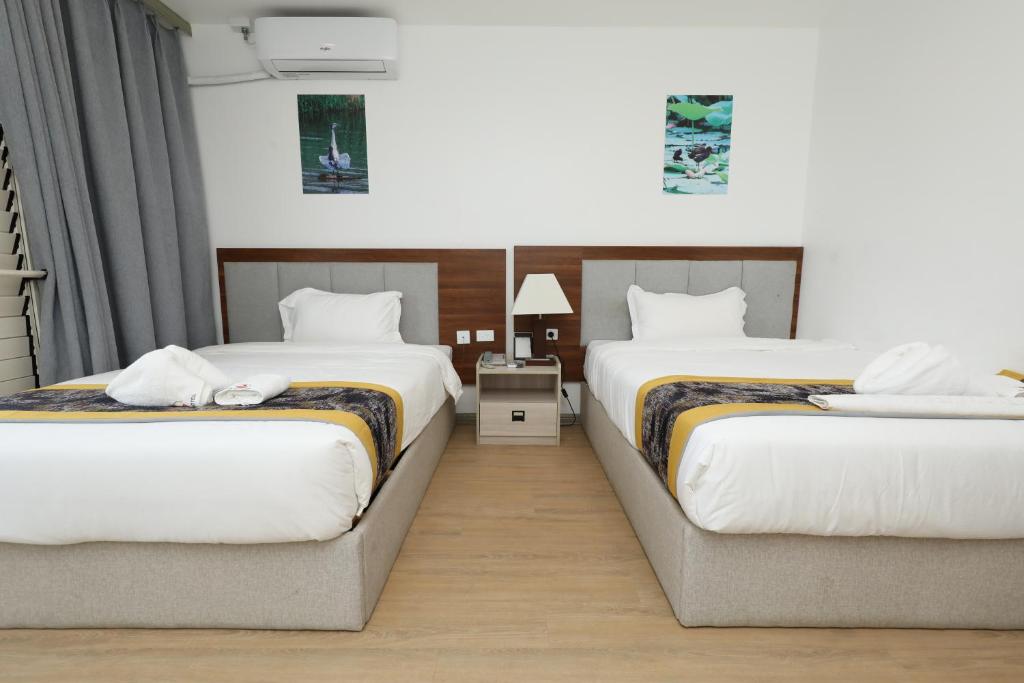 Postel nebo postele na pokoji v ubytování Yue Lai Hotel
