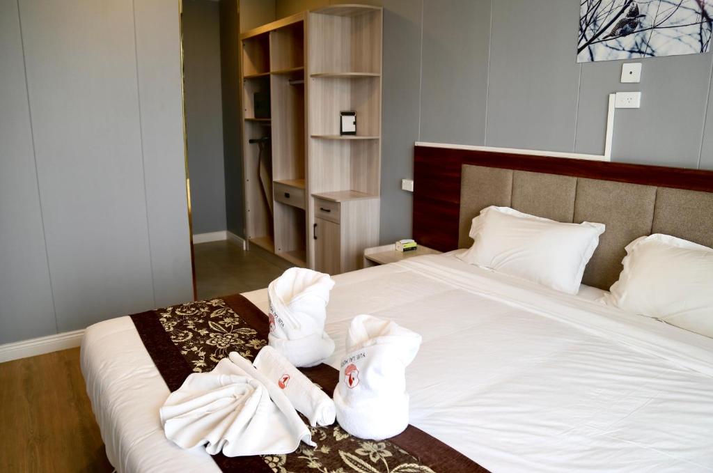 Postel nebo postele na pokoji v ubytování Yue Lai Hotel
