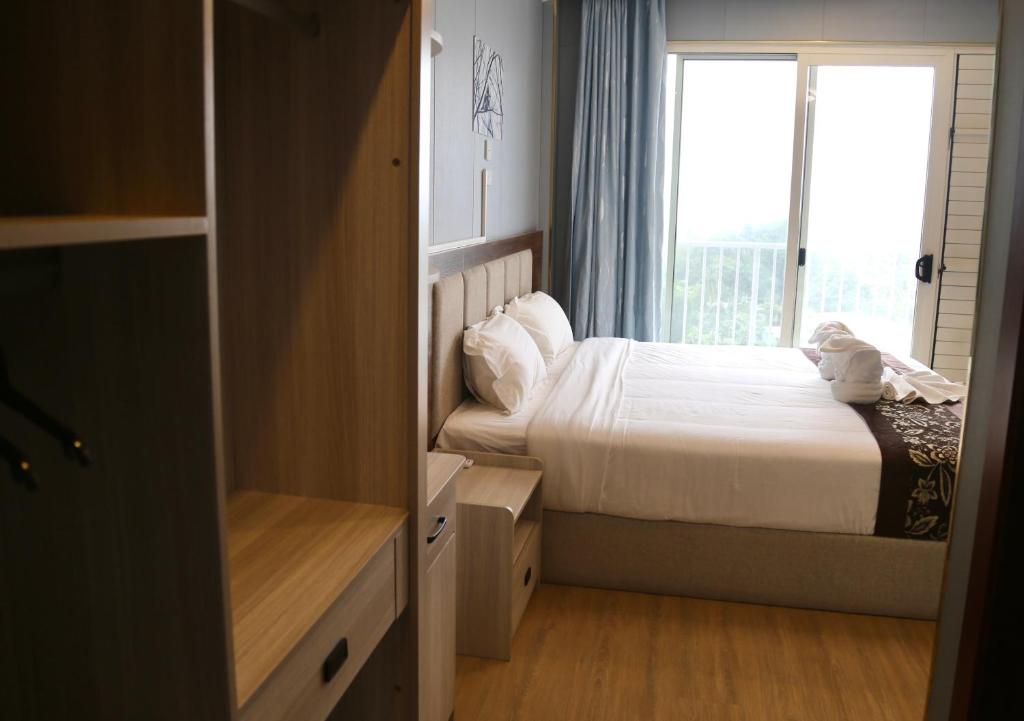 Postel nebo postele na pokoji v ubytování Yue Lai Hotel