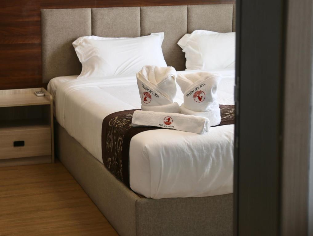 Postel nebo postele na pokoji v ubytování Yue Lai Hotel