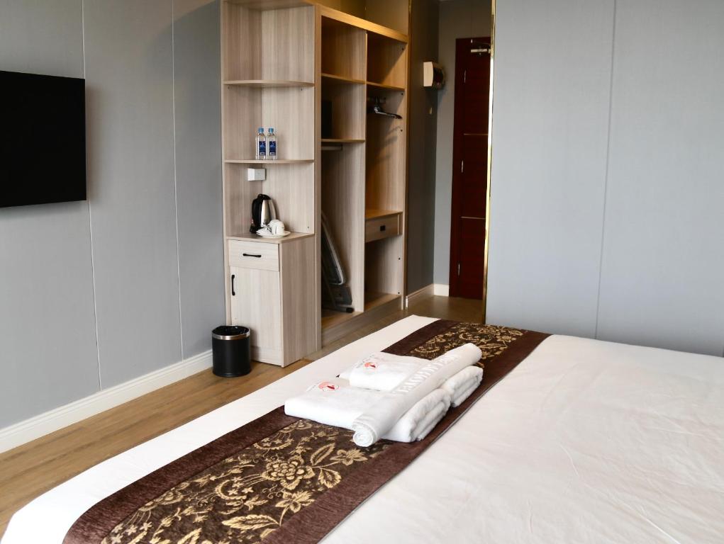 Postel nebo postele na pokoji v ubytování Yue Lai Hotel