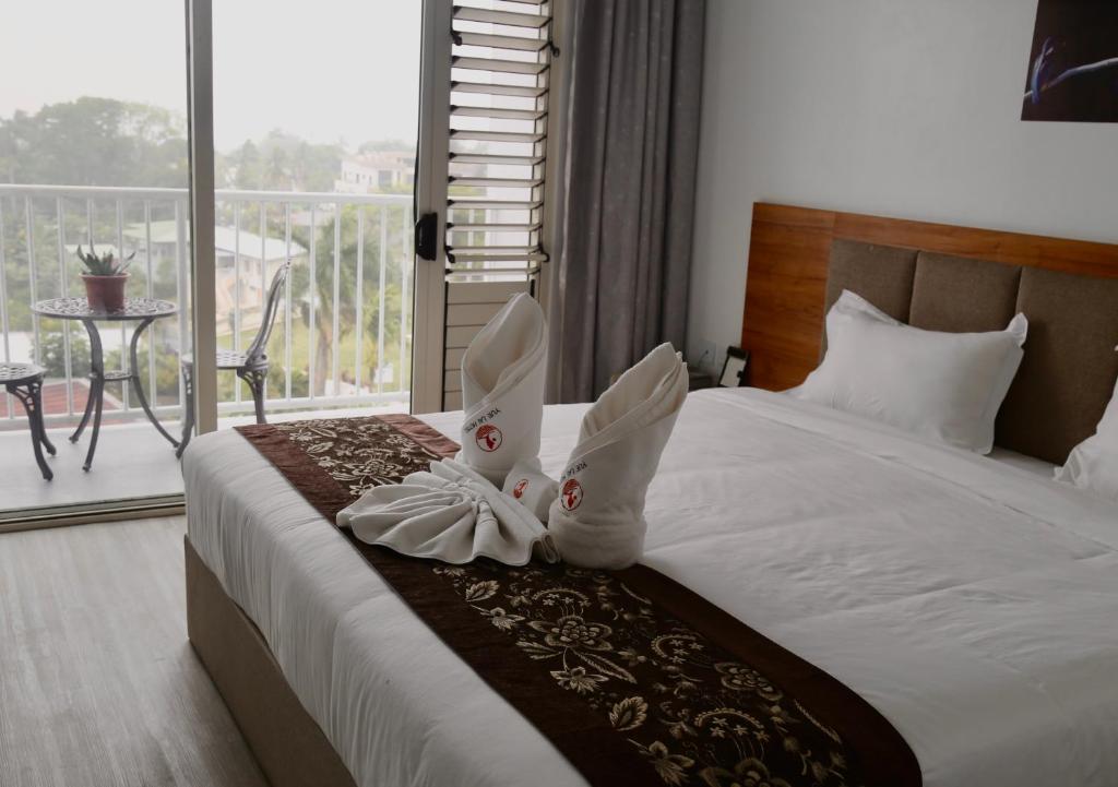 Postel nebo postele na pokoji v ubytování Yue Lai Hotel