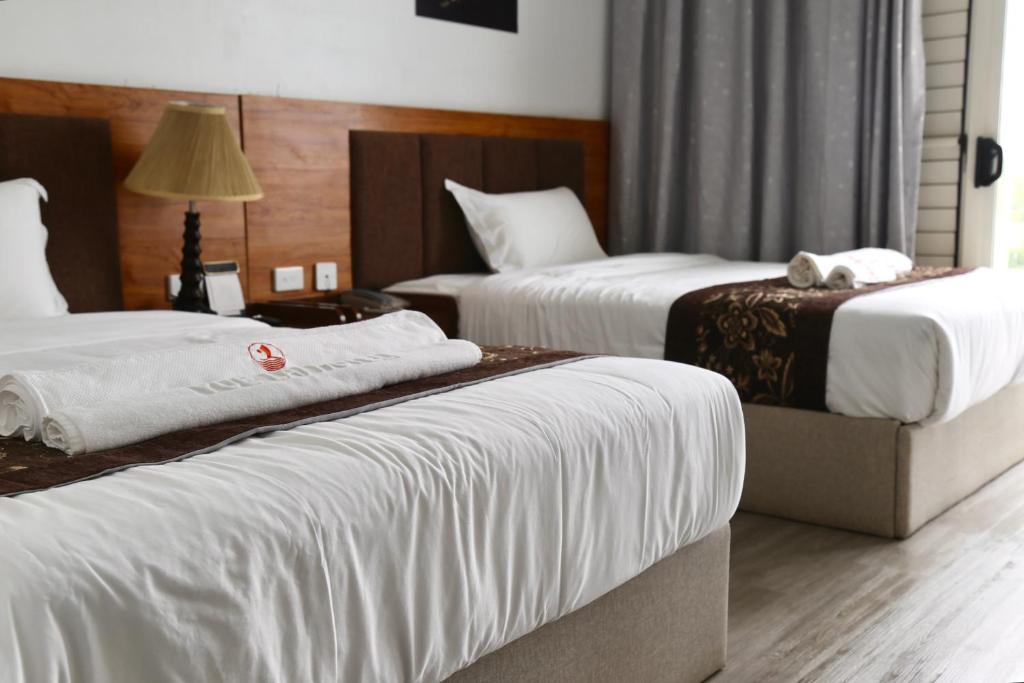 Postel nebo postele na pokoji v ubytování Yue Lai Hotel