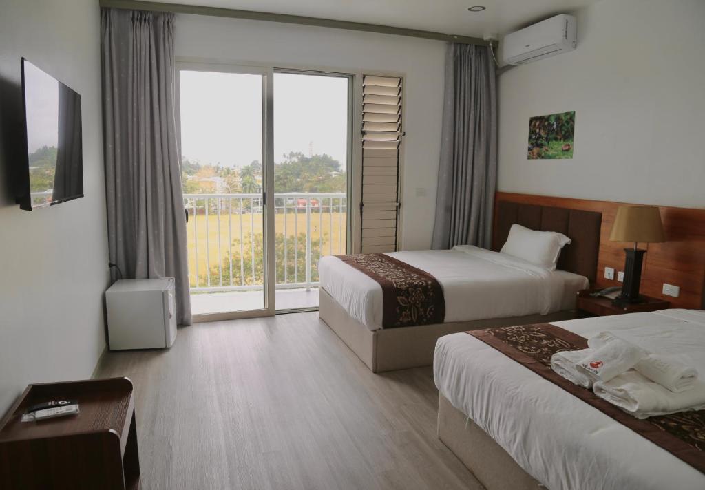Postel nebo postele na pokoji v ubytování Yue Lai Hotel