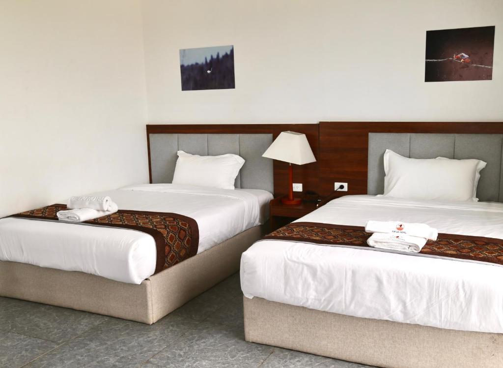 Postel nebo postele na pokoji v ubytování Yue Lai Hotel