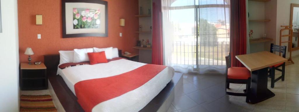 Postel nebo postele na pokoji v ubytování Hotel Real de TX