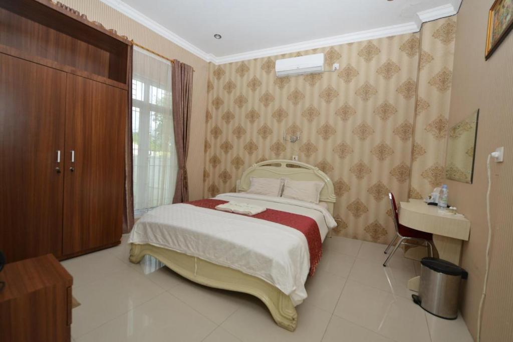 Postel nebo postele na pokoji v ubytování Hotel Alifa Syariah