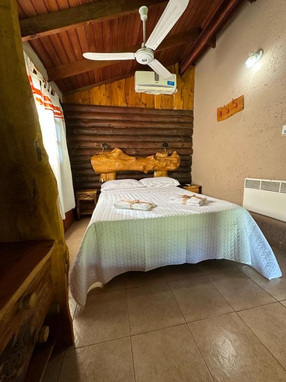a bedroom with a large bed with a wooden ceiling at Cabañas Estancia del Valle in Falda del Carmen