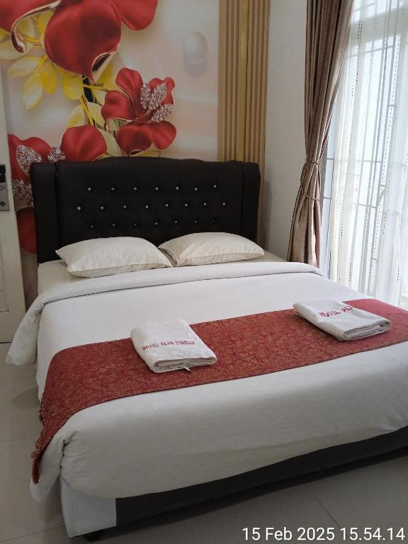 Postel nebo postele na pokoji v ubytování Hotel Alifa Syariah