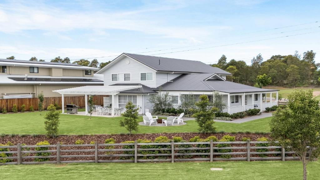 a white house with a black roof at Montauk House in Pokolbin