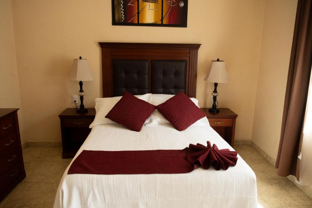 Postel nebo postele na pokoji v ubytování Hotel Villa Bernal