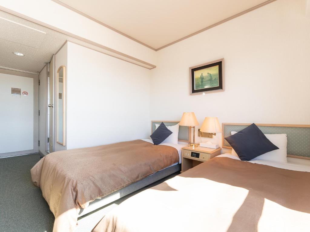 Postel nebo postele na pokoji v ubytování Tabist Hotel Ginga Kisarazu