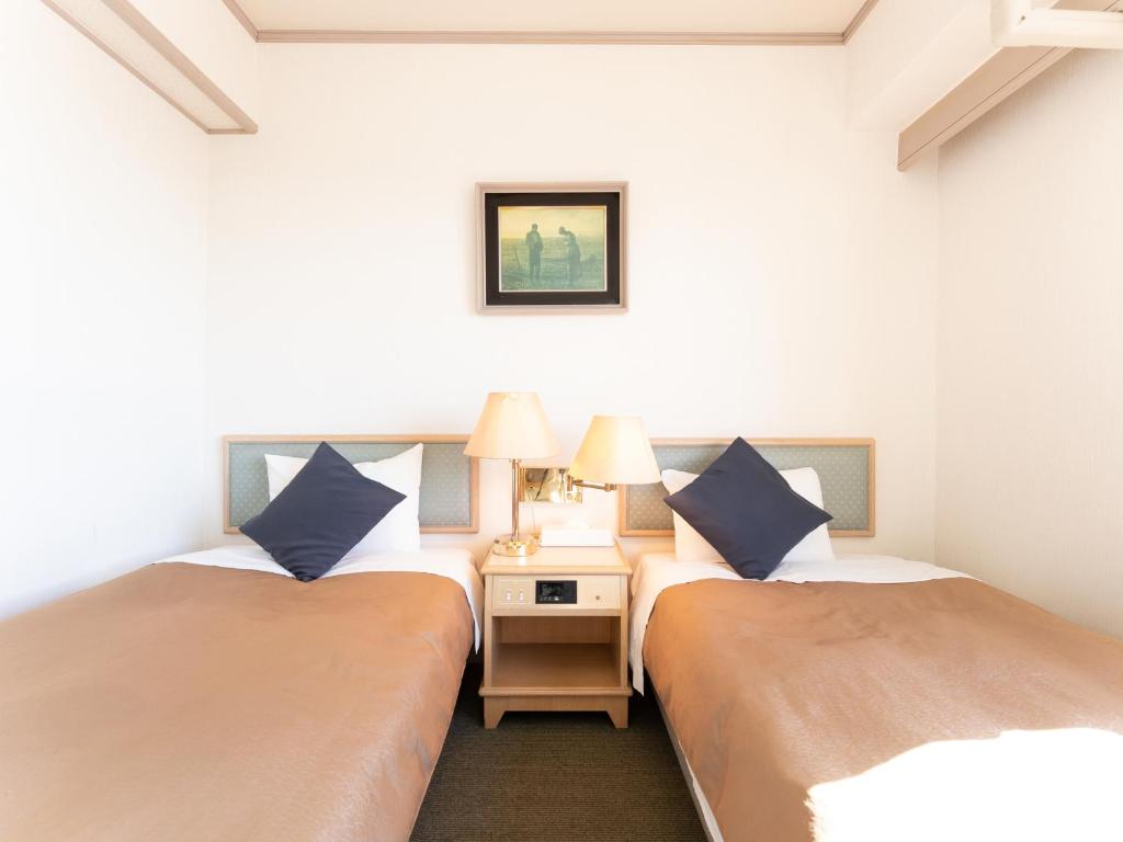 Postel nebo postele na pokoji v ubytování Tabist Hotel Ginga Kisarazu