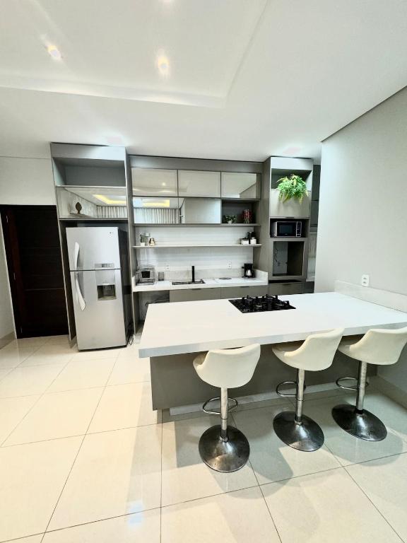 a large kitchen with a white counter and appliances at Sinop Luxury Apartment in Sinop