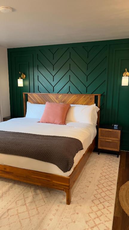 a bedroom with a large bed with green walls at Seaside Serenity in Daytona Beach
