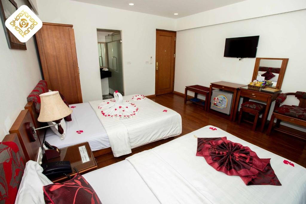 Postel nebo postele na pokoji v ubytování Hoa Hồng Hotel 2 - Xã Đàn