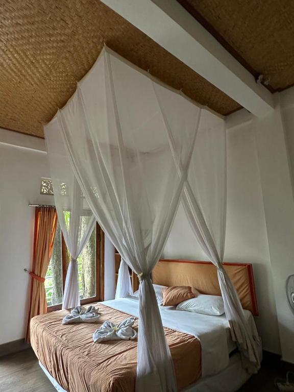 Postel nebo postele na pokoji v ubytování Omunity Bali
