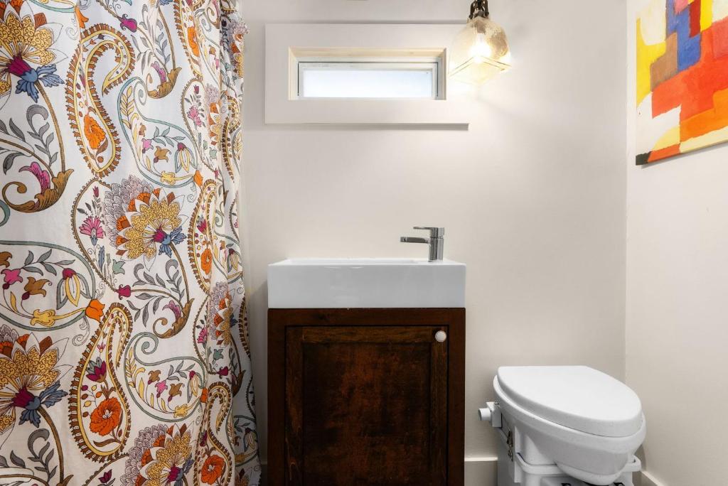 a bathroom with a sink and a toilet at Cozy Tiny Home on an Eco Farm Huge Yard in Austin