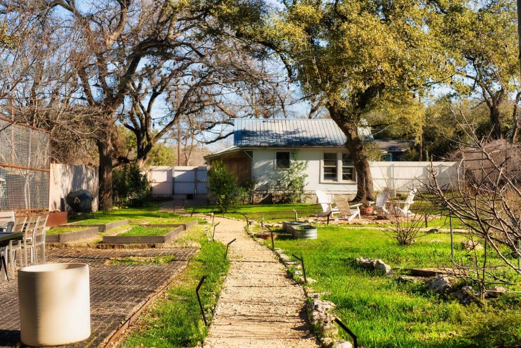 a garden with a house in the background at Cozy Tiny Home on an Eco Farm Huge Yard in Austin