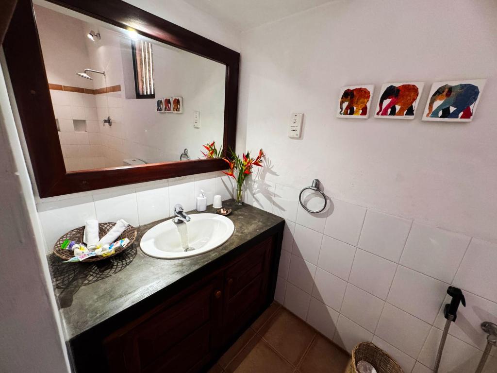 a bathroom with a sink and a mirror at The Garden House Galle - Araliya View Room in Galle