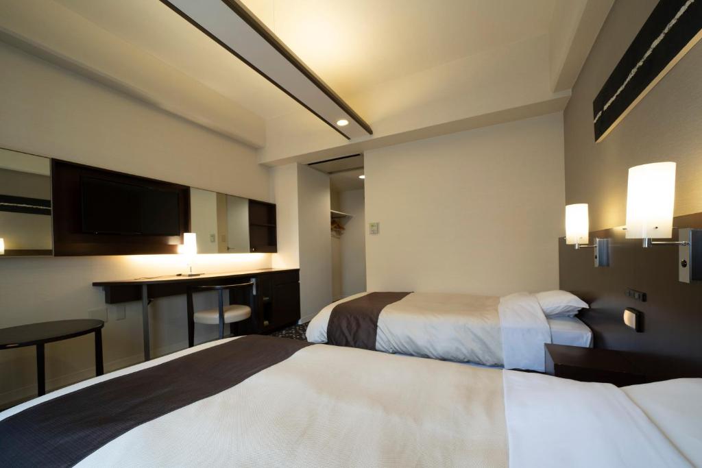 Postel nebo postele na pokoji v ubytování Hotel Binario Umeda