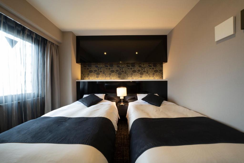 Postel nebo postele na pokoji v ubytování Hotel Binario Umeda