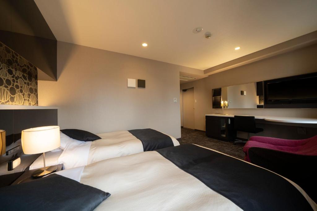 Postel nebo postele na pokoji v ubytování Hotel Binario Umeda