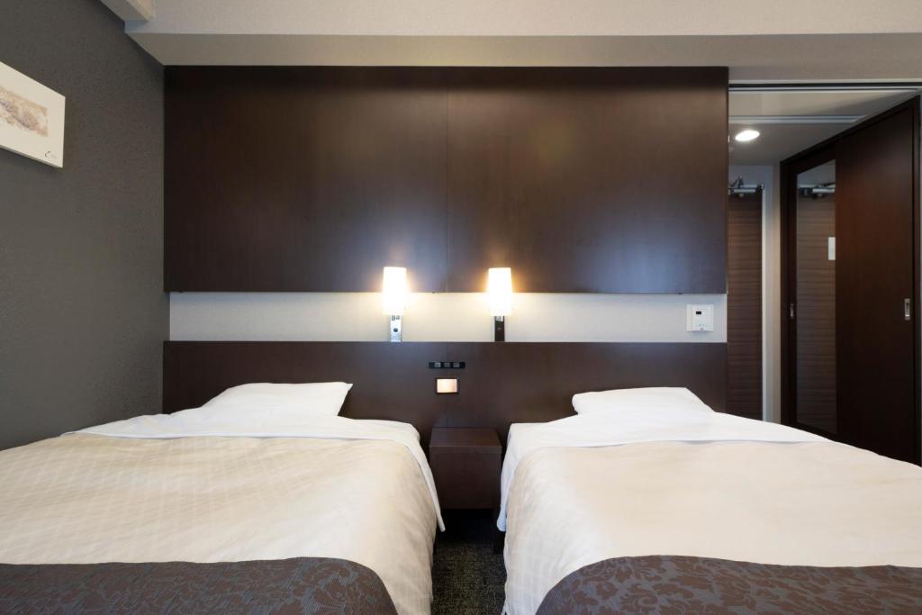 Postel nebo postele na pokoji v ubytování Hotel Binario Umeda