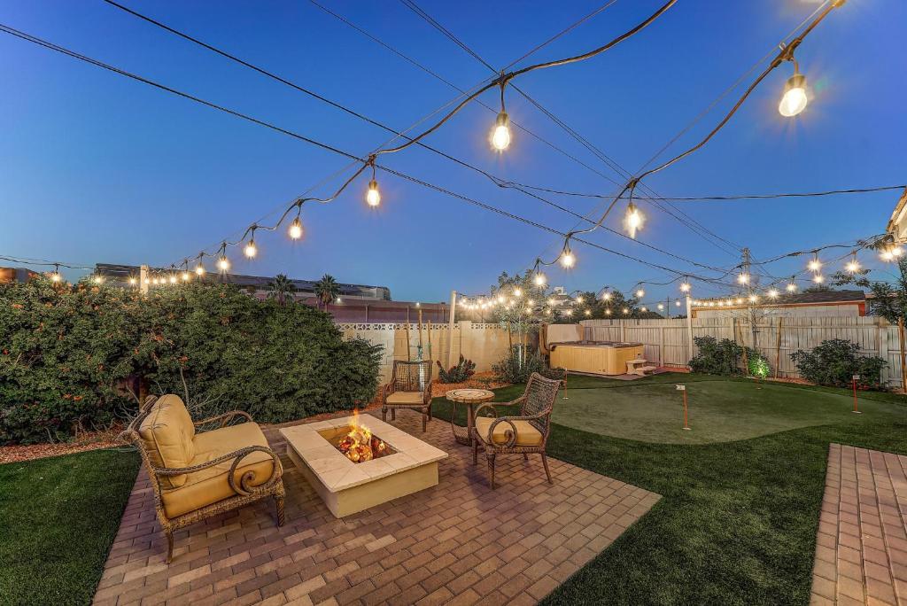 a patio with a fire pit and chairs and lights at Tempe Joy House With Backyard Sanctuary By Asu in Tempe