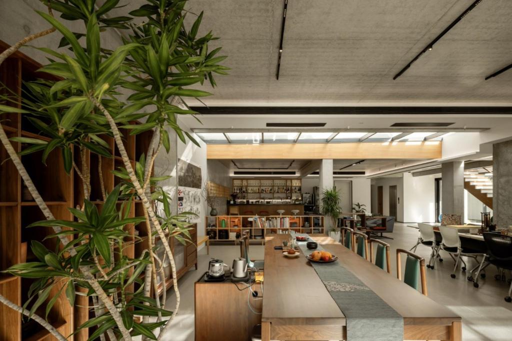 a large room with a table and some plants at Miss Gu LAKE VILLA in Suzhou